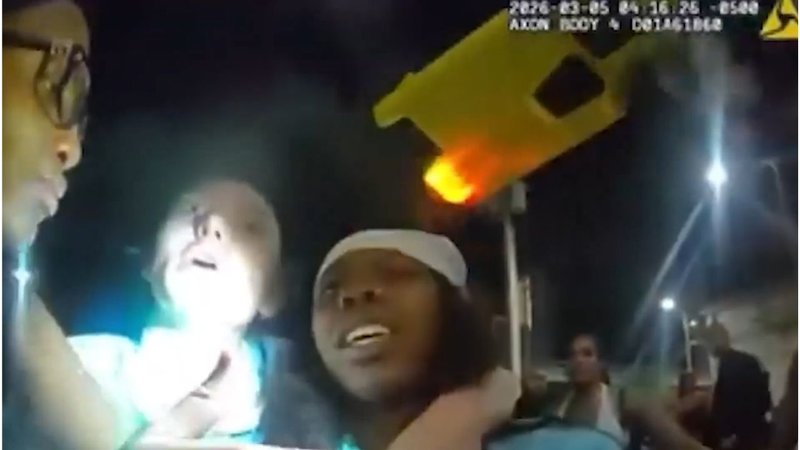 A screenshot of the newly released footage, showing Arike Ogunbowale and Paige Bueckers as a police officer points a taser at Bueckers’s face.