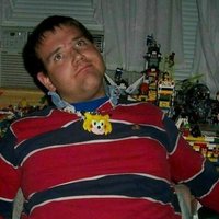 Chris Chan surrounded by lego builds and action figures.