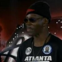 Larry Plat in sunglasses and an Atlanta jersey