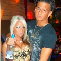 guy holding a bottle of vodka with his arm around a blonde woman