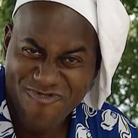 Ainsley Harriott in a chef's hat