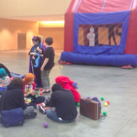 Dashcon sad scene of a mostly empty convention hall with a single jumping castle and a tiny inflatable ball pit