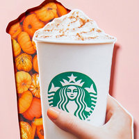 manicured hand moving a Starbucks cup shaped cutout to reveal pumpkins