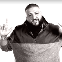 DJ Khaled DJ Khaled with his signature 1 finger gesture on both hands in a black and white photo