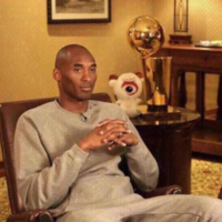 Petty Kobe Bryant Kobe Bryant sitting in chair wit hands folded and a petty disapproving look on his face