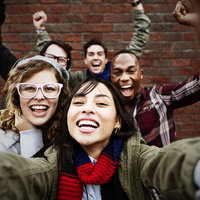 racially diverse group of young adults taking a selfie