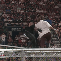 Undertaker pushing Mankind off a cell