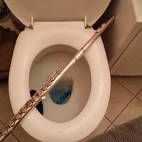 Shittyflute flute placed across a toilet seat