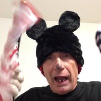 Man in Mickey Mouse hat waving a USA flag