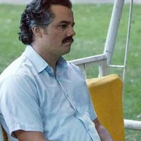 Pablo Escobar Waiting Wagner Moura as Pablo Escobar sitting on a swing