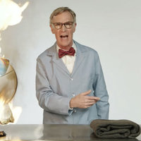 Bill Nye next to a burning globe