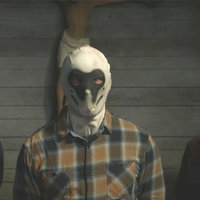 Three people wearing Rorschach inkblot masks