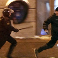 Protester Running from Riot Police