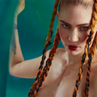 Grimes' Pregnancy Topless photo of Grimes with her hair in braids and wearing purple contact lenses