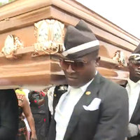 several pallbearers in formal uniforms carrying a coffin on their shoulders