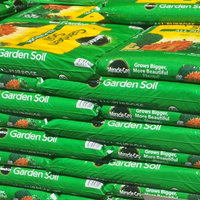 green bags of garded soil in a hardware store lowes