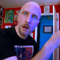 Doug Walker Pointing at Computer meme depicting a bald man in a red room explaining something.