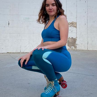Ana Coto in blue gym wear crouching on skate shoes