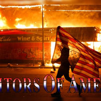 Photograph of a person holding an american flag upside down in front of a burning convenient store