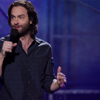 comedian chris d'elia in a black shirt performing standup comedy