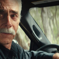 sam elliott as bobby maine backing up his car 