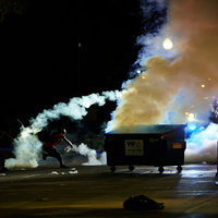 A photo of protesters throwing back tear gas shot by police in Kenosha, Wisconsin during the 2020 Jacob Blake Protests.