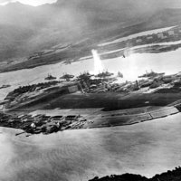 Photograph taken from a Japanese plane during the torpedo attack on ships moored on both sides of Ford Island shortly after the beginning of the Pearl Harbor attack.