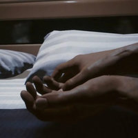 Cyberpunk 2077 V sleeping in bed in an awkward position.