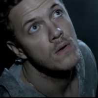 Imagine dragons radioactive music video scene depicting the lead singer staring up into the sky.