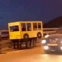 Blursed Images A Blursed Image of a group of people walking in a cardboard bus costume on the highway.