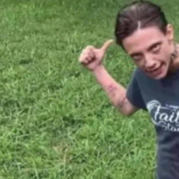 Hosed Karen woman pointing behind her with thumb