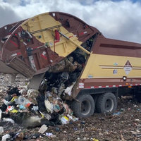 Trauma Dumping slang term depicted by an image of a garbage truck dumping trash into a landfill.