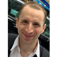 A photo of Mikey Miles smiling.