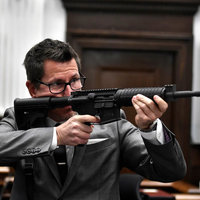 Photograph of prosecutor Thomas Binger pointing a gun during Kyle Rittenhouse's trial in Wisconsin.