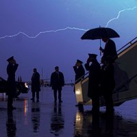 DarkMAGA DarkMAGA meme example depicting an image of Trump exiting a plane as a thunderstorm takes place in the background.