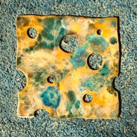 Cheese Touch Cheese Touch meme example depicting a moldy slice of swiss cheese.