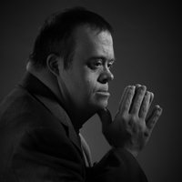 Retard Chad meme format depicting a black and white image of a man with downs.