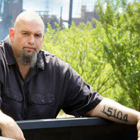 John Fetterman A photo of politician John Fetterman leaning against a railing.