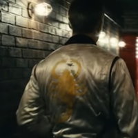 Drive Jacket depicting ryan gosling in the movie drive wearing a white jacket with a yellow scorpion on its back.