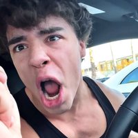 Image shows YouTube fitness influencer Lexx Little sitting in his car going "gorilla mode" as he shouts "WE GO JIM."