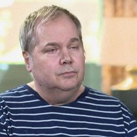 John Hinckley Jr., during a television interview wearing a striped shirt.
