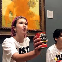 Just Stop Oil protestors throwing tomato soup on a van Gogh painting in 2022.