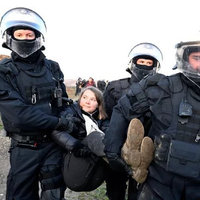 Greta Thunberg being carried by police after her arrest in Germany.