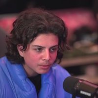 Photo of Matan Even speaking into a microphone.