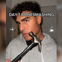 Bonesmashing / Bone Smashing trend depicting a man holding a hammer up to his face.