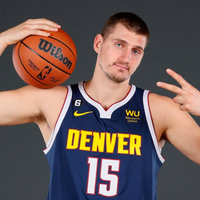 A photo of nba player Nikola Jokic posing with a basketball.