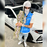 A photo of rapper Punchmade Dev holding stacks of cash.