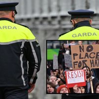Two Garda policemen and a photo of protestors for the bill.