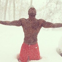 half-naked football player marquise goodwin stands on his knees in the snow