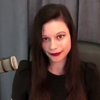 A photo of Emily Youcis with a microphone on what appears to be a podcast.